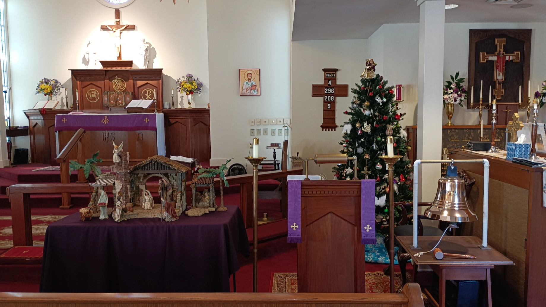 Christmas Alter Inside St. Timothy's ACC. Nativity Scene sits in front with the Christmas Tree lit with beautiful lights.